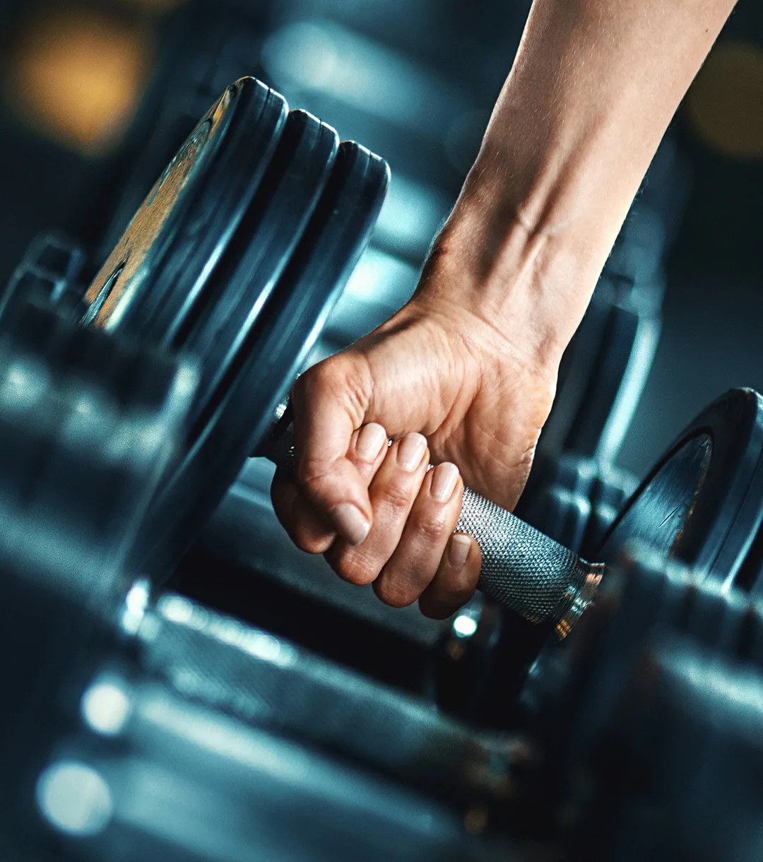 person grabbing free weights